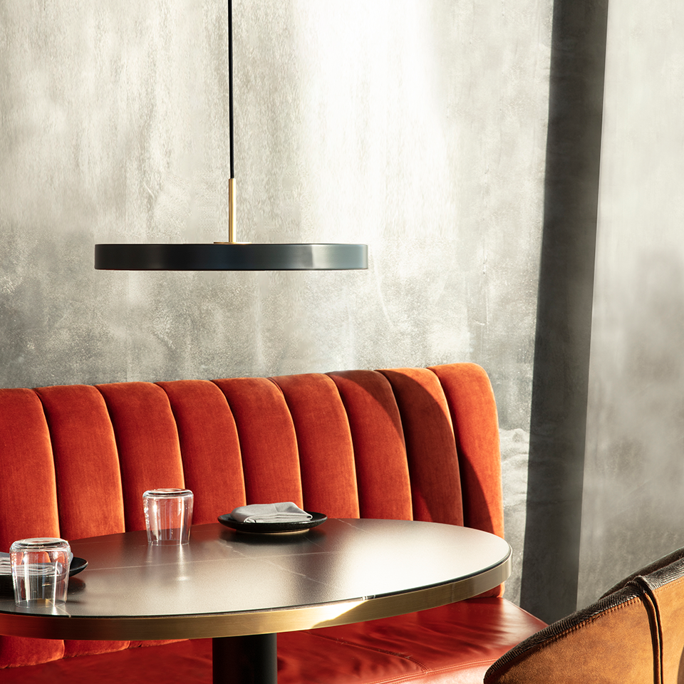 UMAGE Asteria LED Pendant in Anthracite Grey with Brass Connector — styled interior view