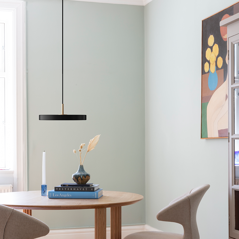 UMAGE Asteria Mini LED Pendant in Black with Brass Connector — styled interior view 4