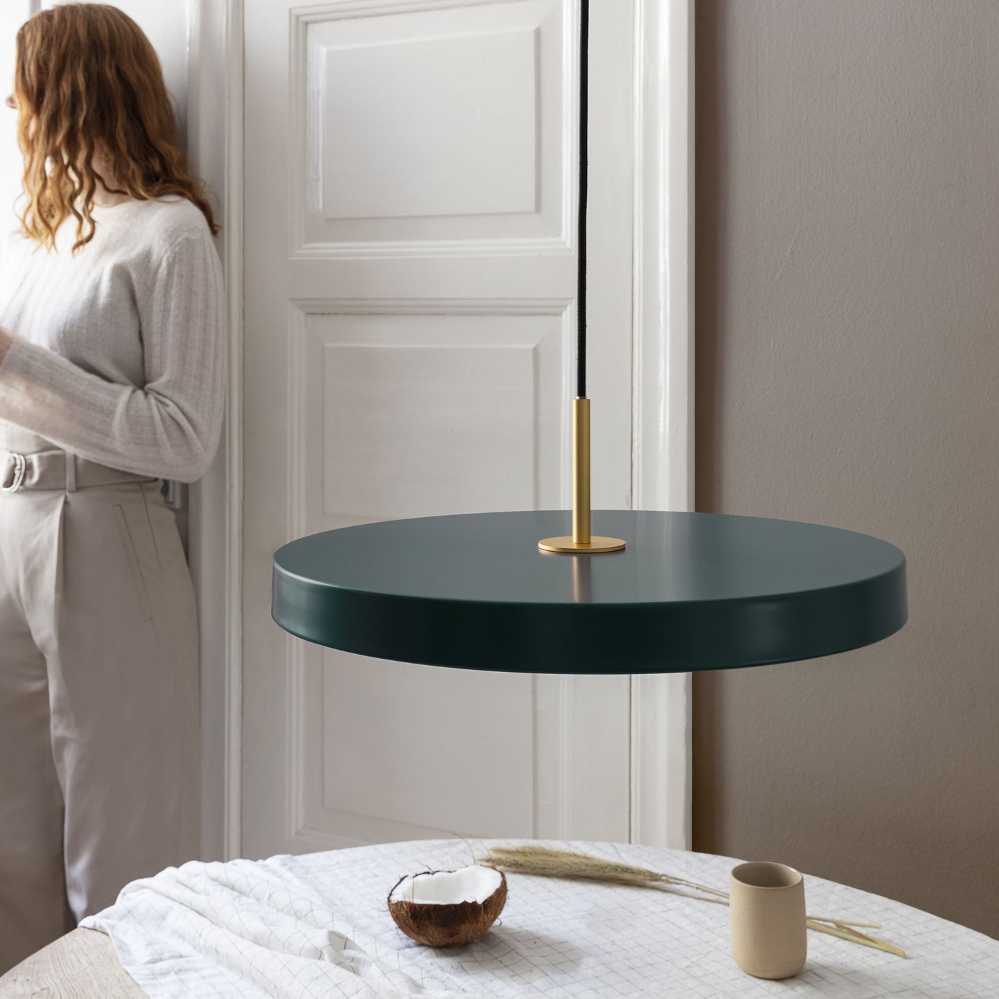 UMAGE Asteria LED Pendant in Forest Green with Brass Connector — styled interior view 3