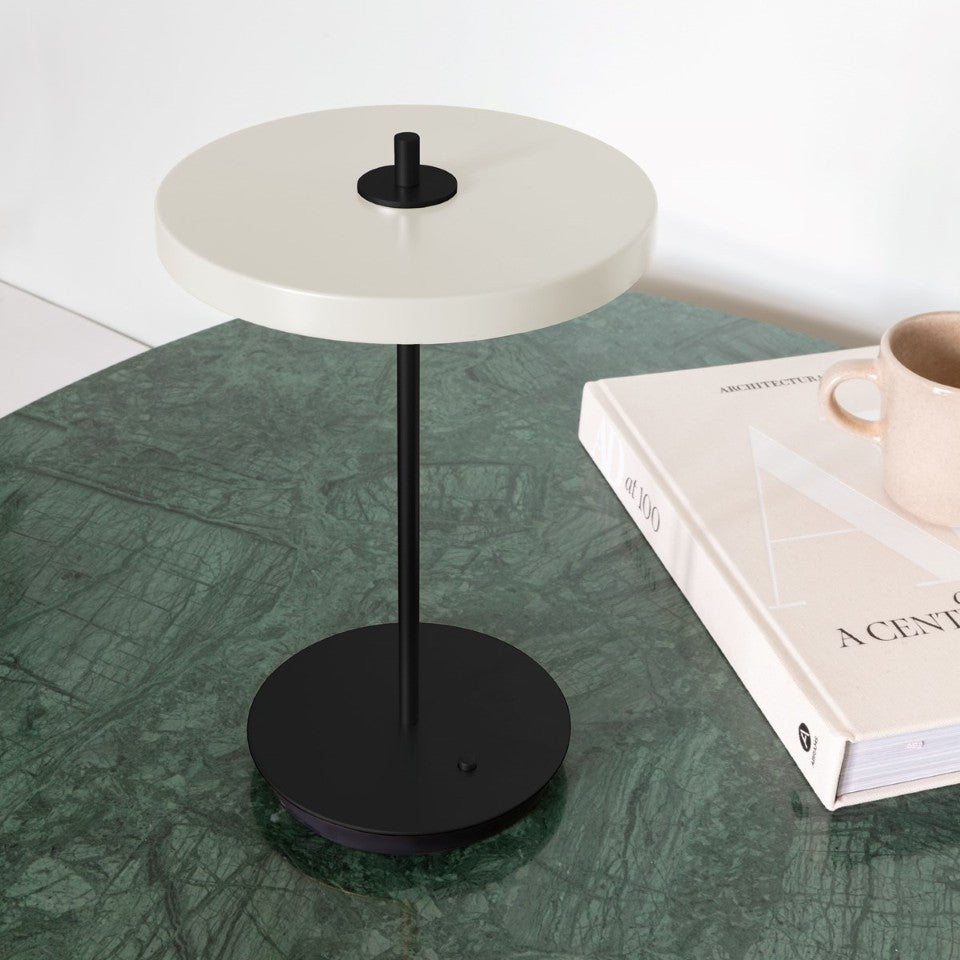 UMAGE Asteria Move Portable Table Lamp - Pearl White / Black — styled interior view