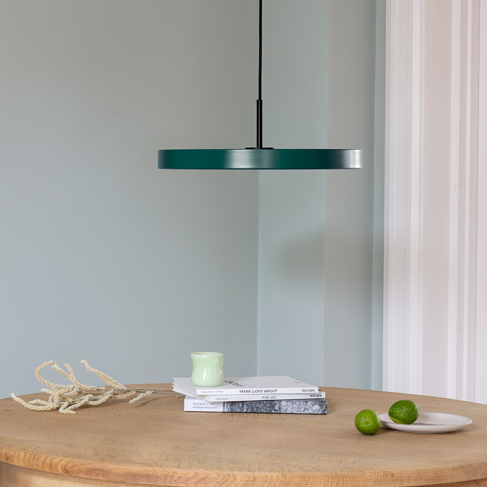 UMAGE Asteria LED Pendant in Forest Green with Black Connector — styled interior view