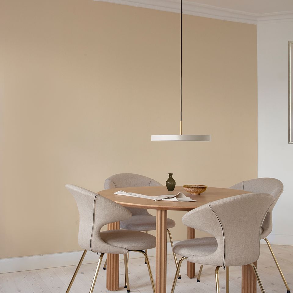 UMAGE Asteria LED Pendant in Pearl White with Brass Connector — styled interior view