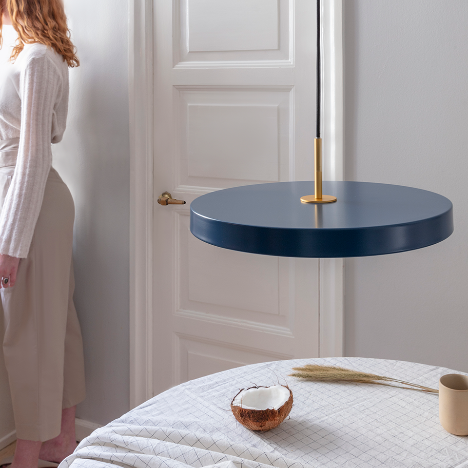 UMAGE Asteria LED Pendant in Petrol Blue with Brass Connector — styled interior view