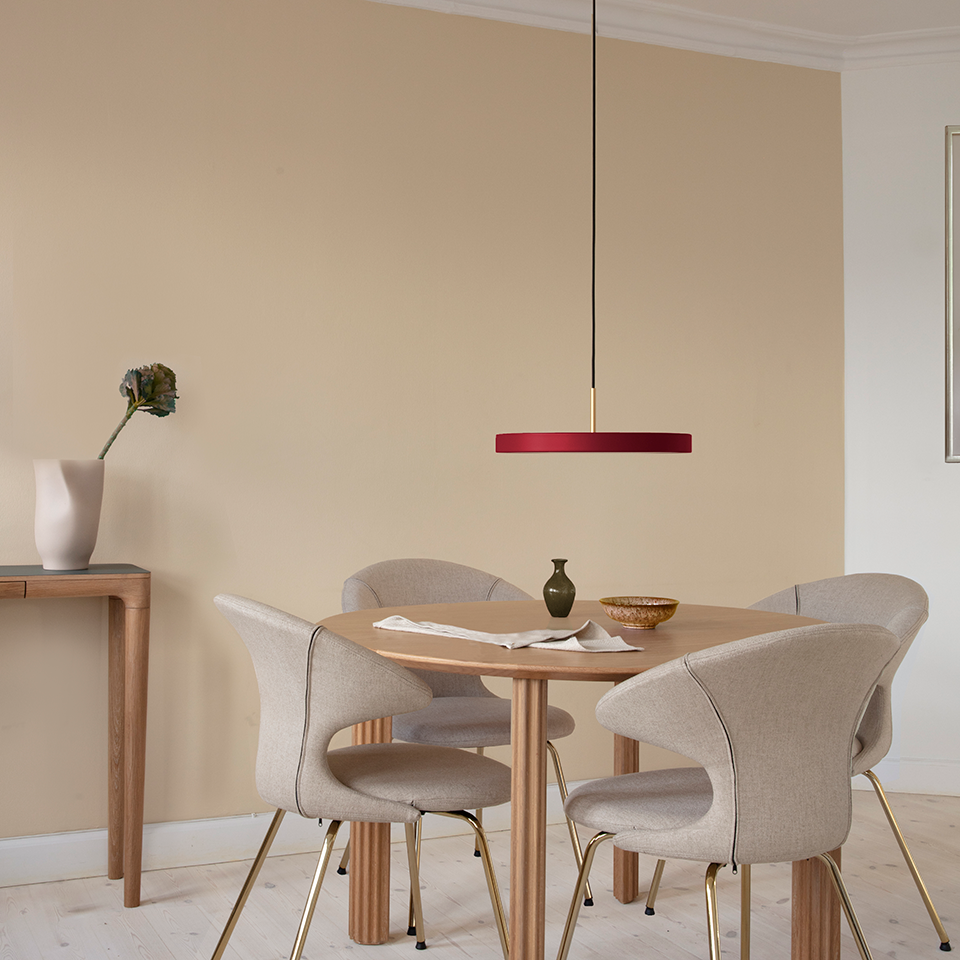 UMAGE Asteria LED Pendant in Ruby Red with Brass Connector — styled interior view 3