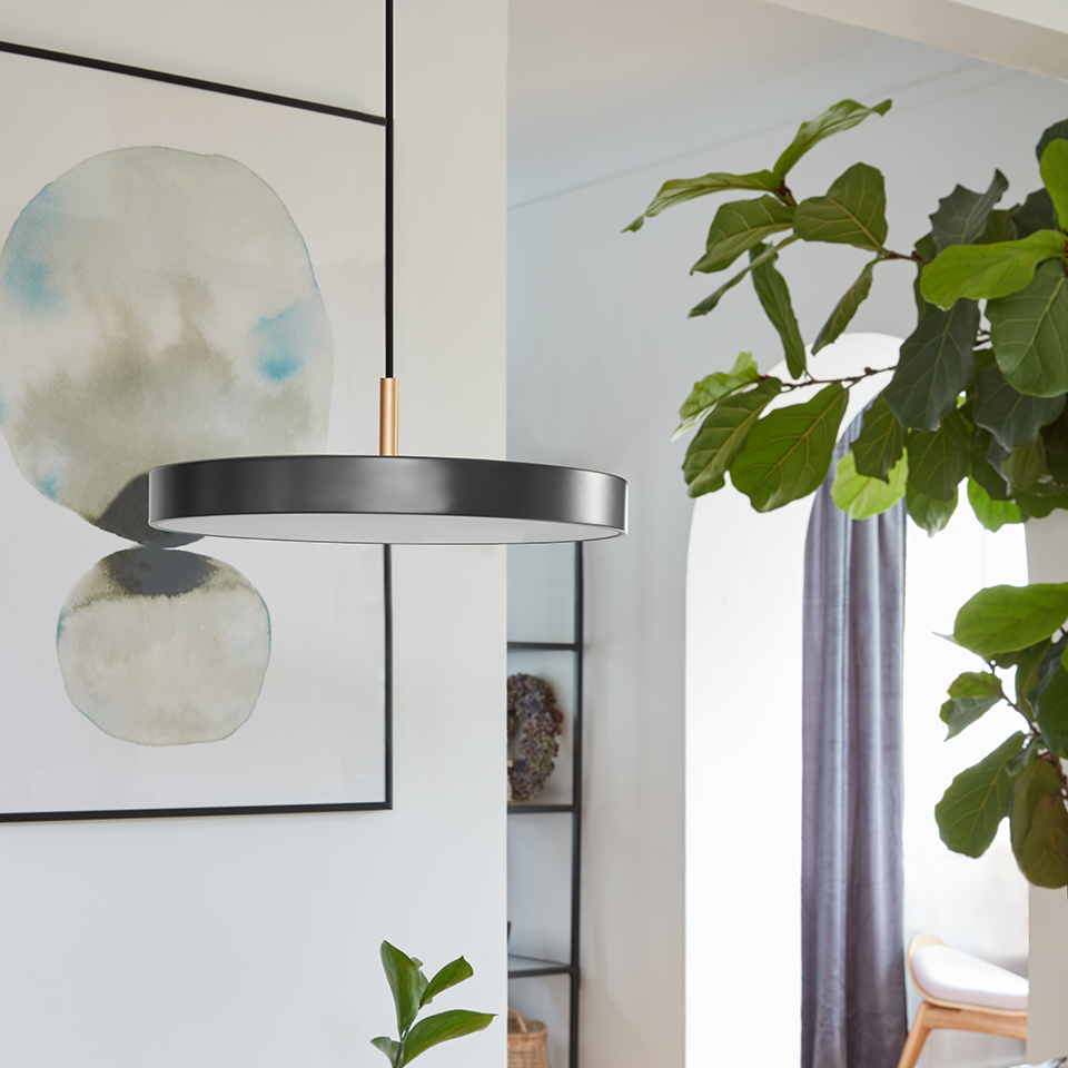 UMAGE Asteria Mini LED Pendant in Anthracite Grey with Brass Connector — styled interior view