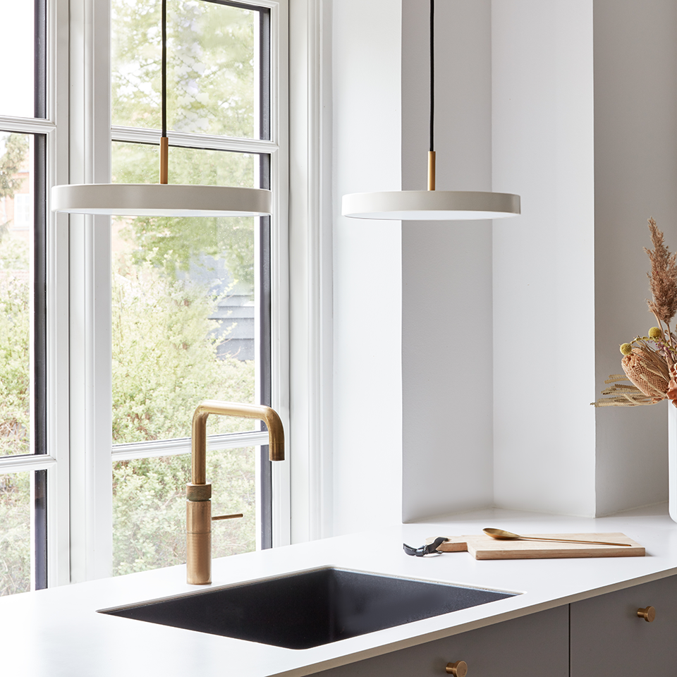 UMAGE Asteria Mini LED Pendant in Pearl White with Brass Connector — styled interior view 2