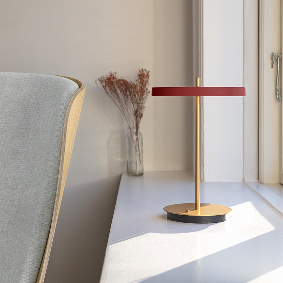 UMAGE Asteria Move LED Portable Table Lamp in Ruby Red — styled interior view