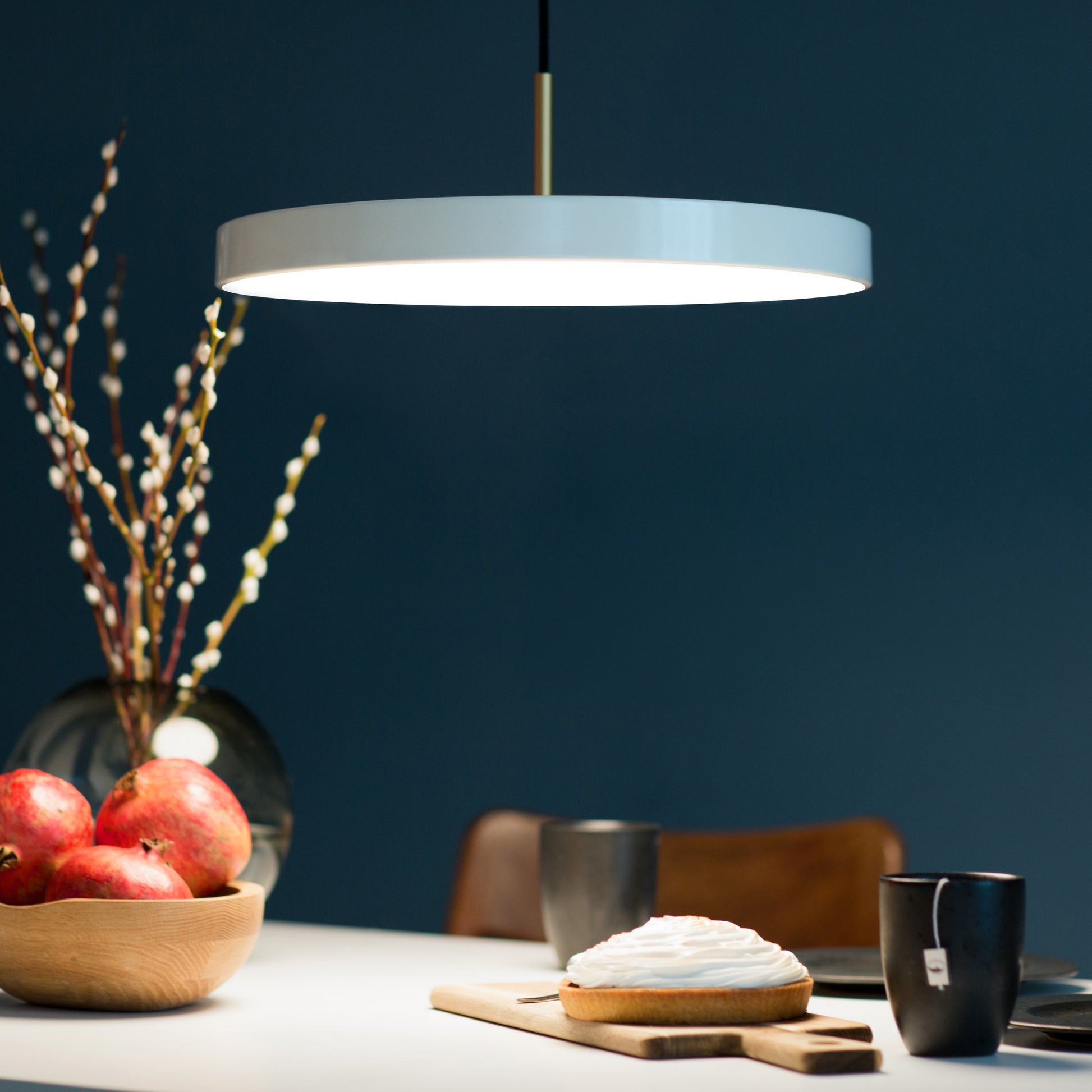 UMAGE Asteria LED Pendant in Pearl White with Brass Connector — styled interior view 2