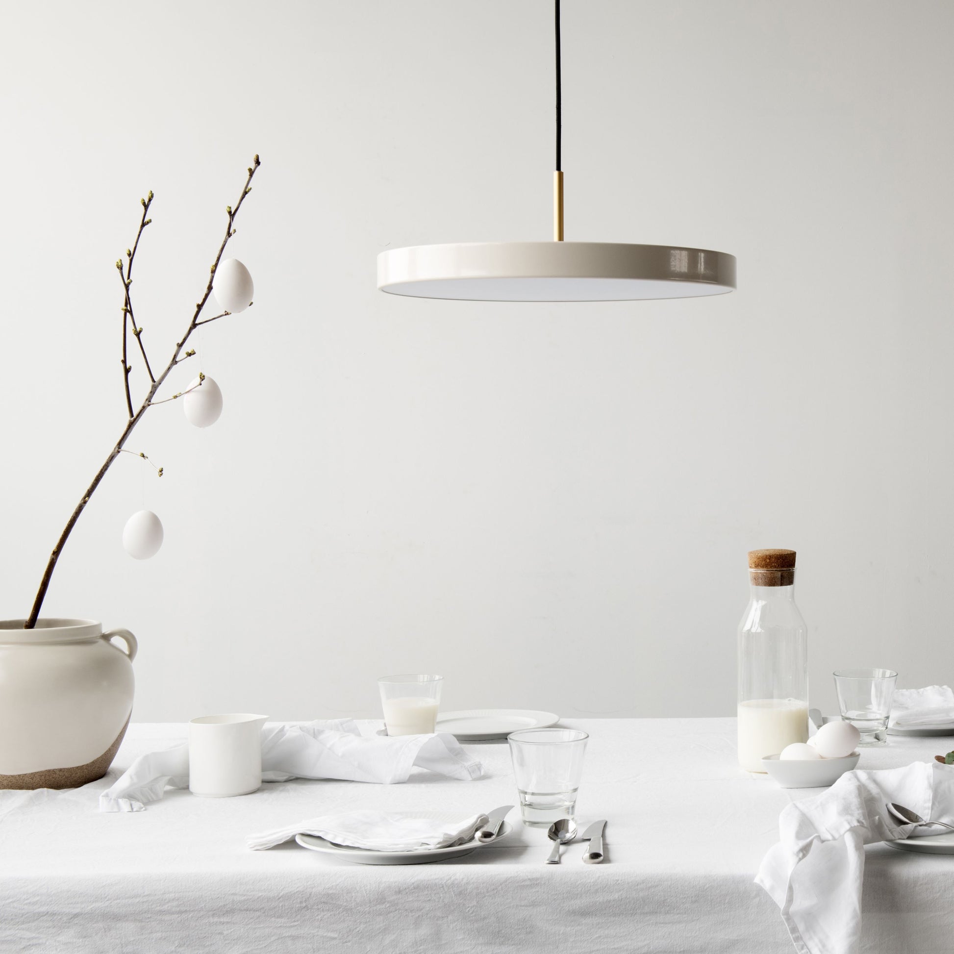 UMAGE Asteria LED Pendant in Pearl White with Brass Connector — styled interior view 3