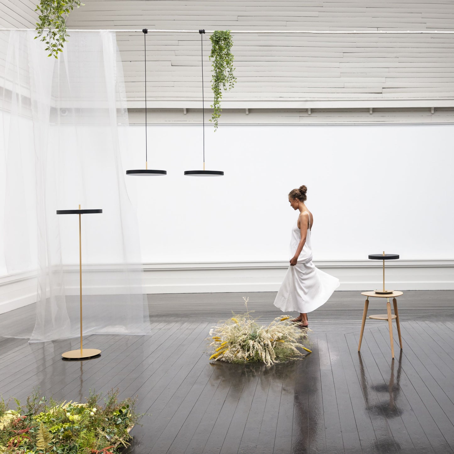 UMAGE Asteria Mini LED Pendant in Black with Brass Connector — styled interior view