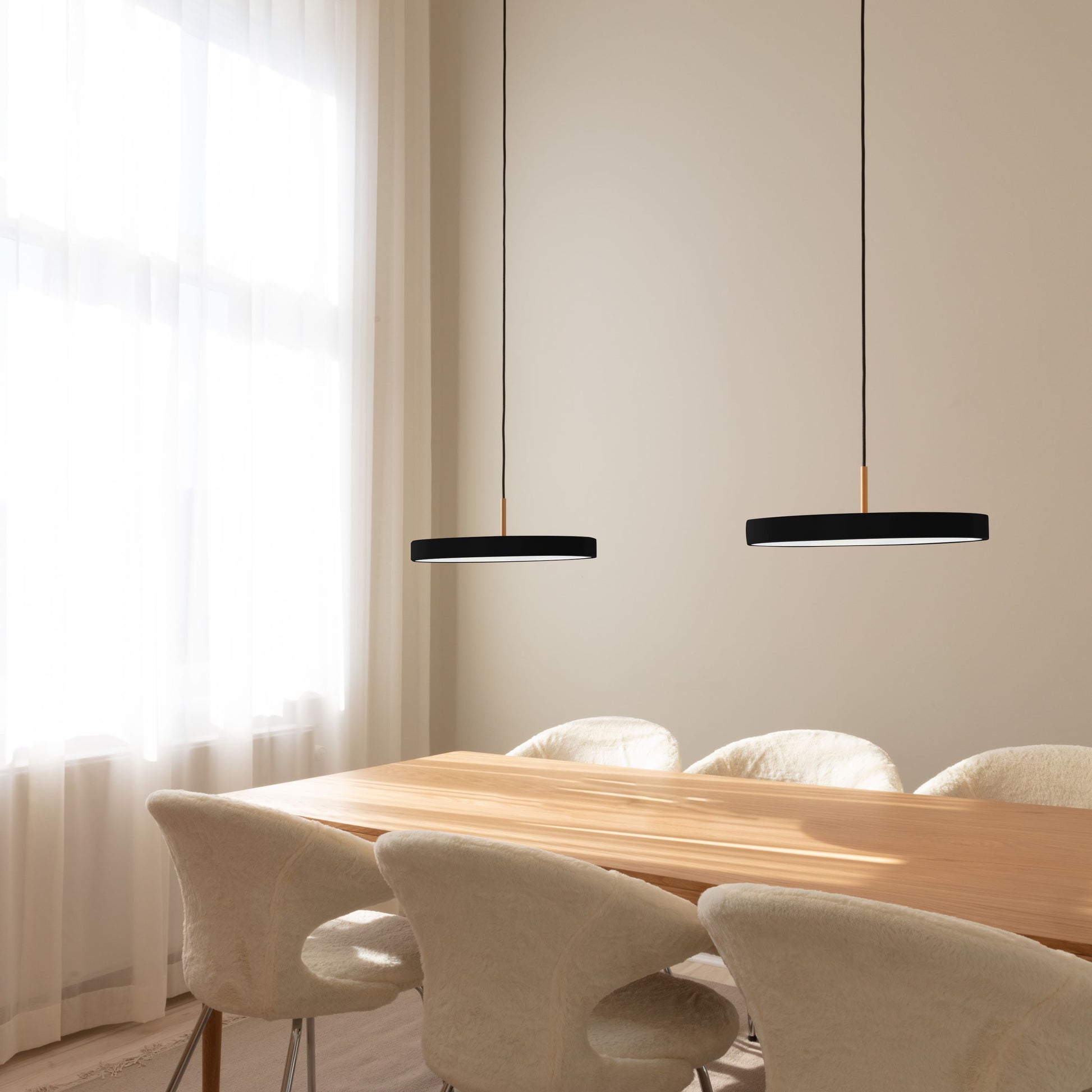 UMAGE Asteria LED Pendant in Black with Brass Connector — styled interior view 2