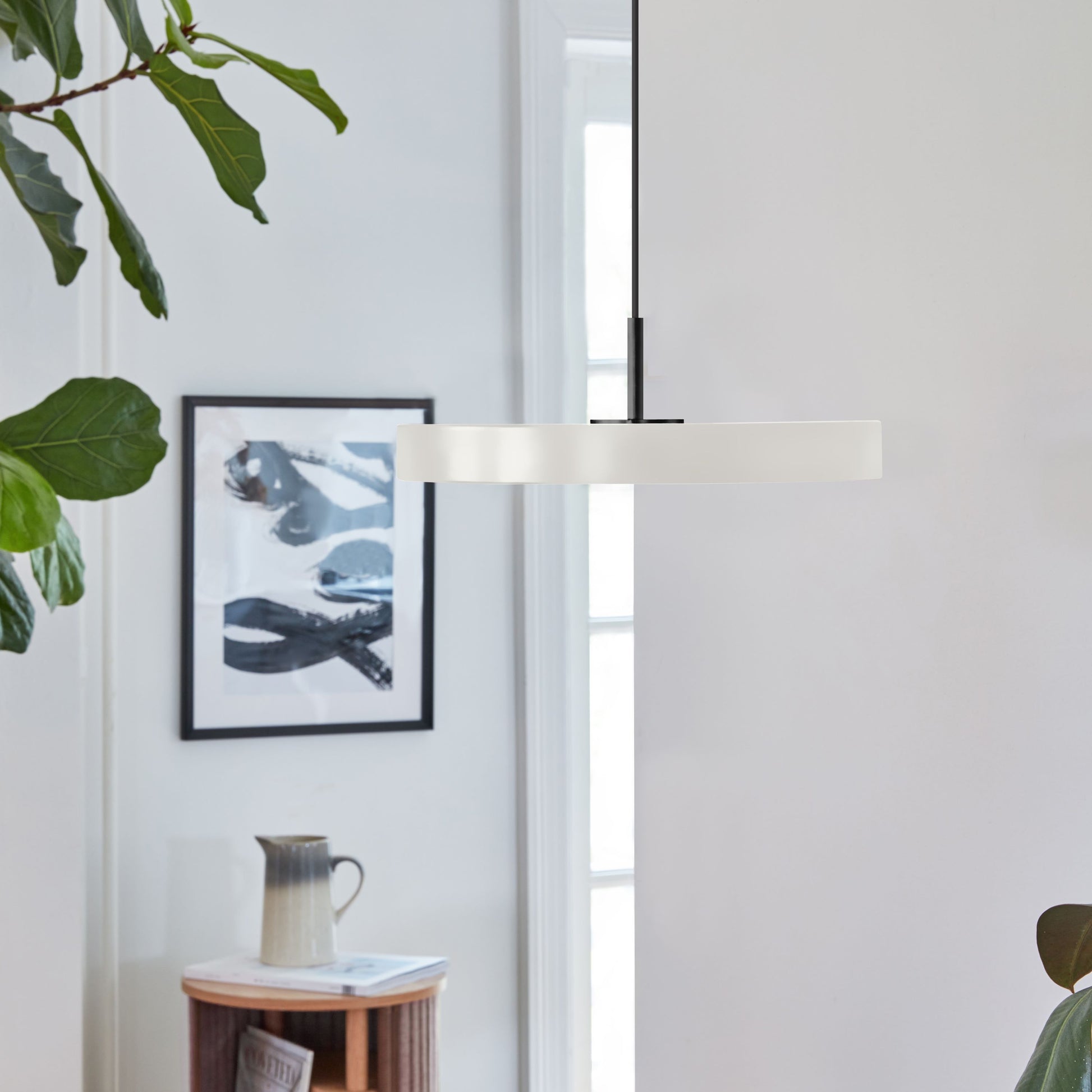 UMAGE Asteria Mini LED Pendant in Pearl White with Black Connector — styled interior view