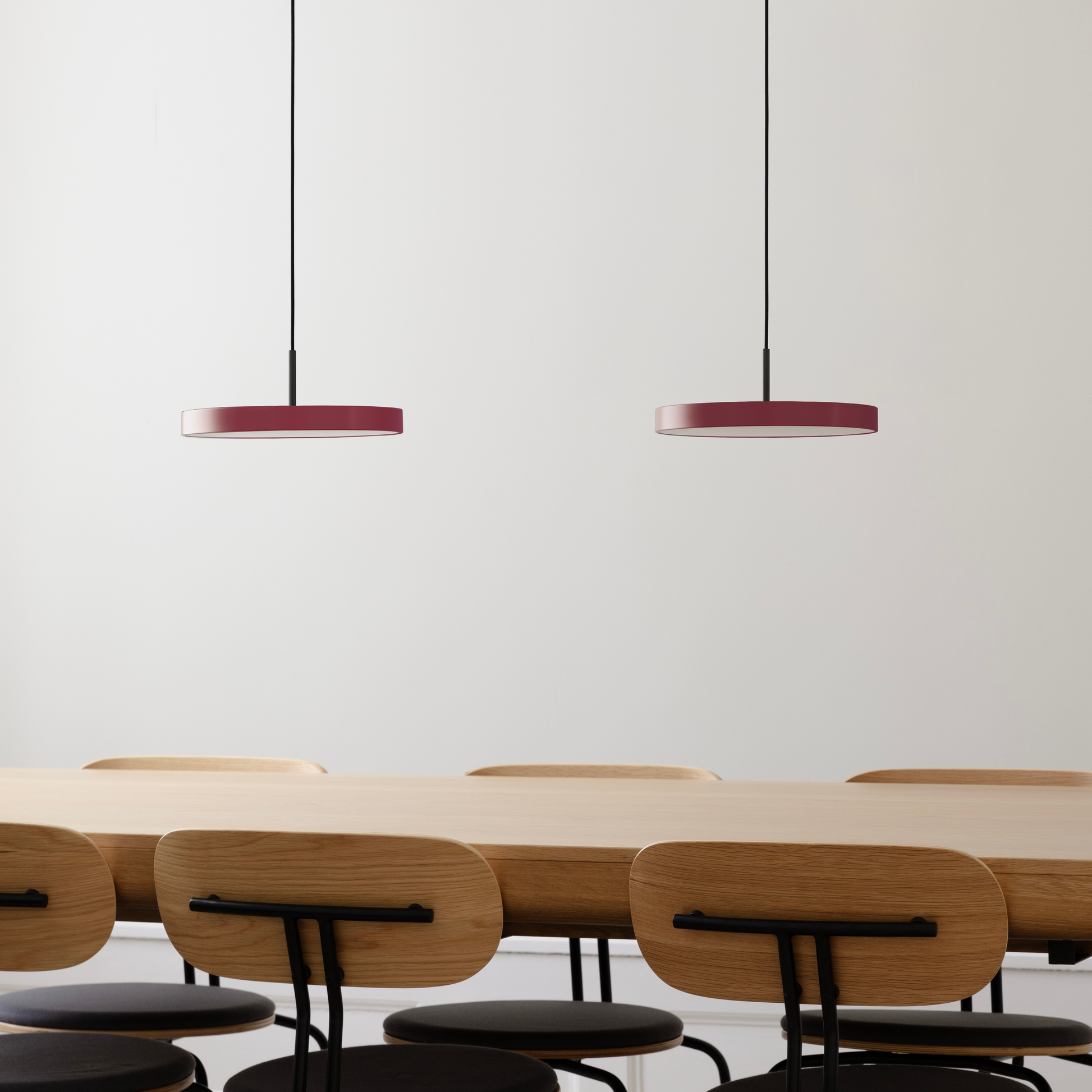 UMAGE Asteria Mini LED Pendant in Ruby Red with Black Connector — styled interior view
