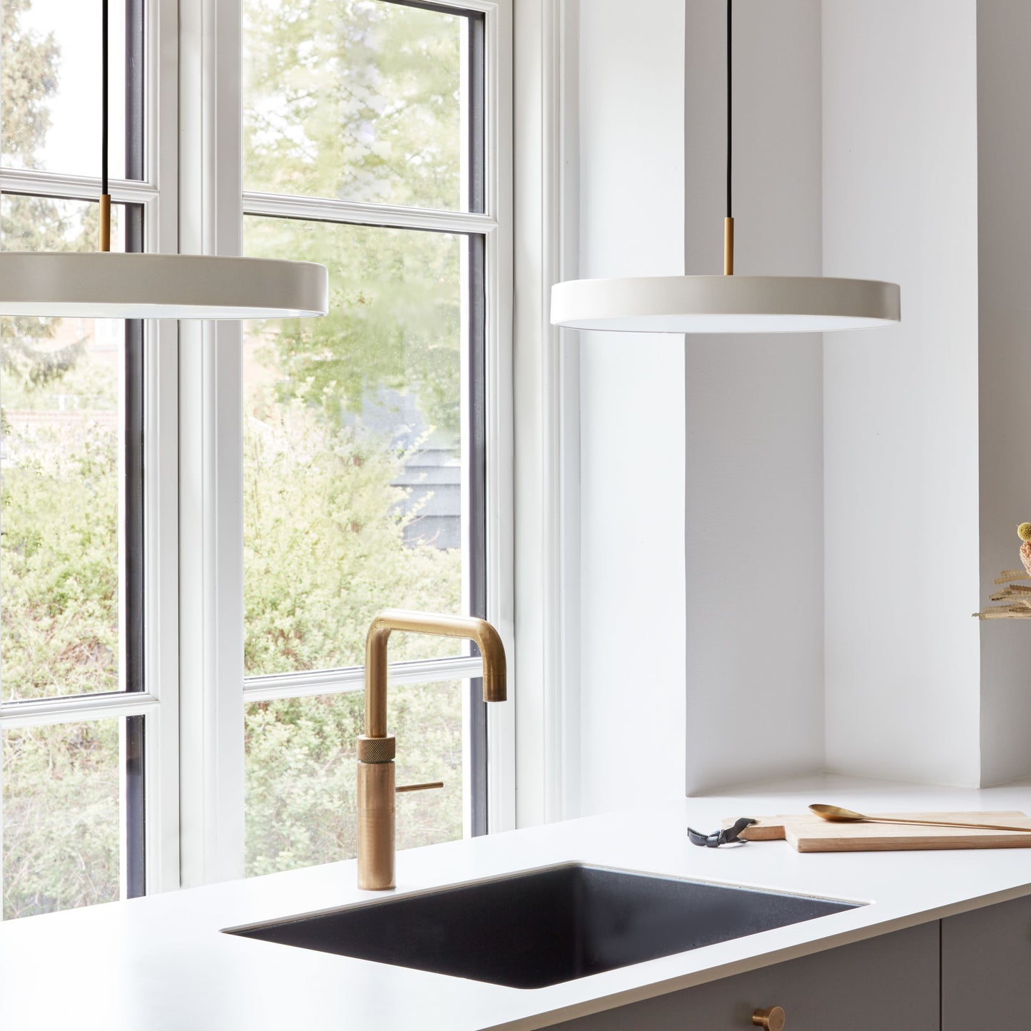 UMAGE Asteria LED Pendant in Pearl White with Brass Connector — styled interior view 5