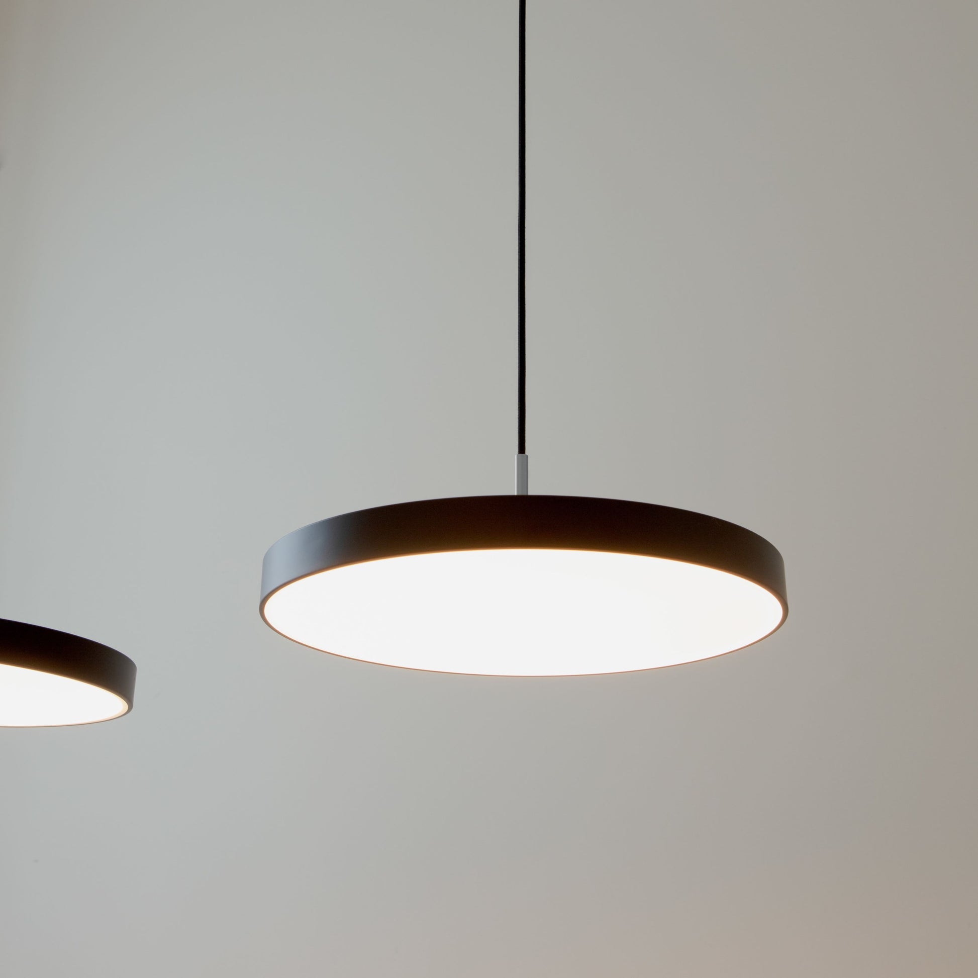 UMAGE Asteria LED Pendant in Black with Steel Connector — styled interior view 3