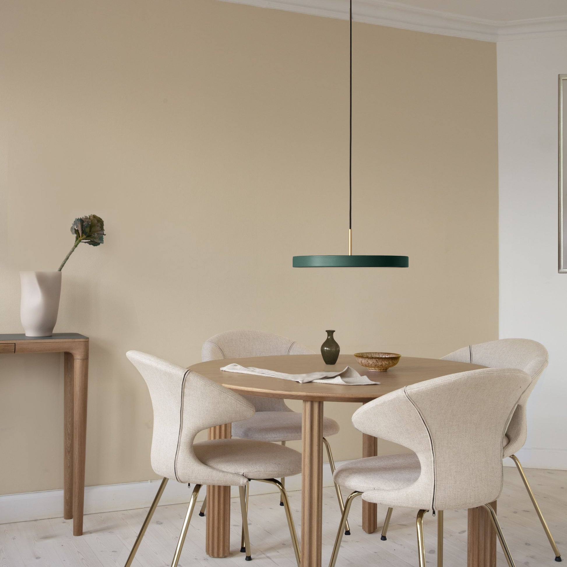 UMAGE Asteria LED Pendant in Forest Green with Brass Connector — styled interior view