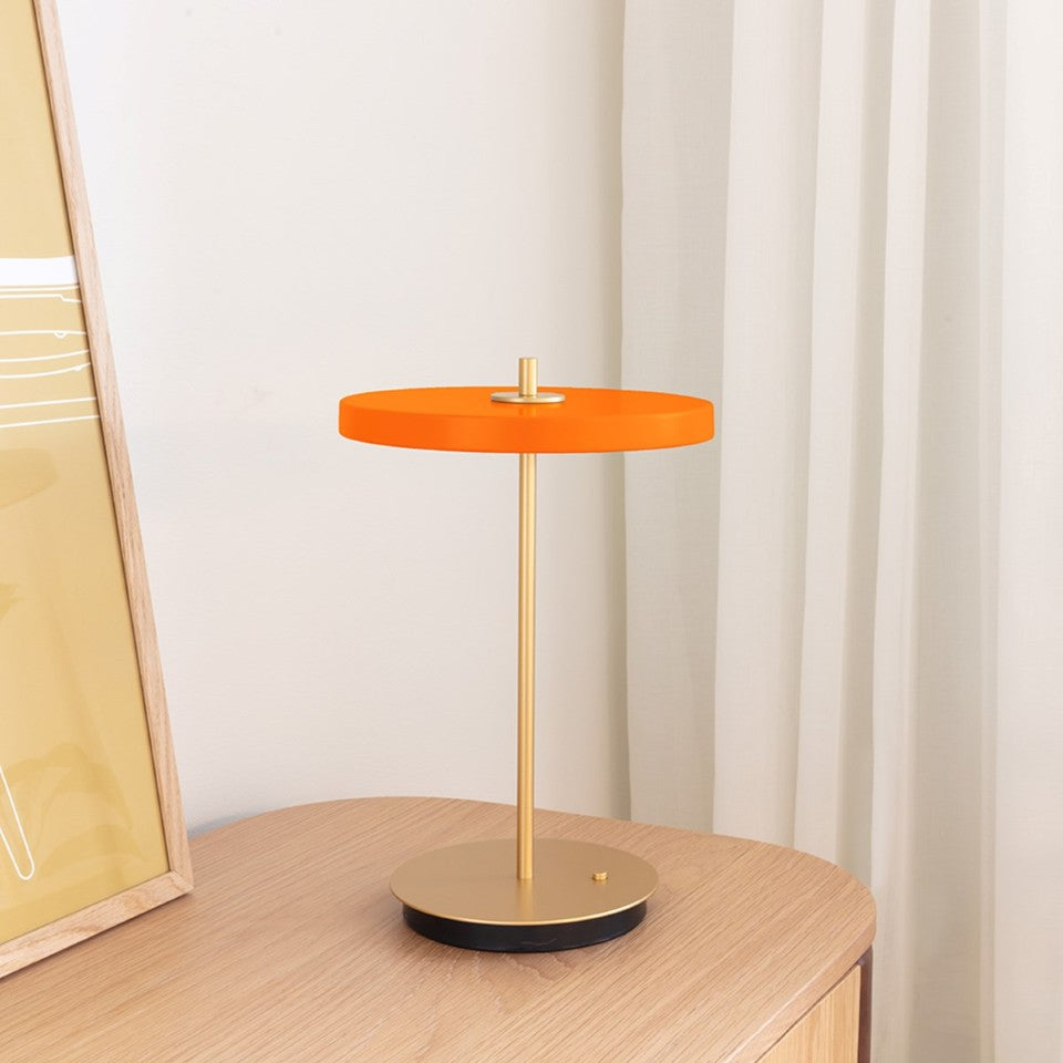 UMAGE Asteria Move LED Portable Table Lamp in Nuance Orange — styled interior view