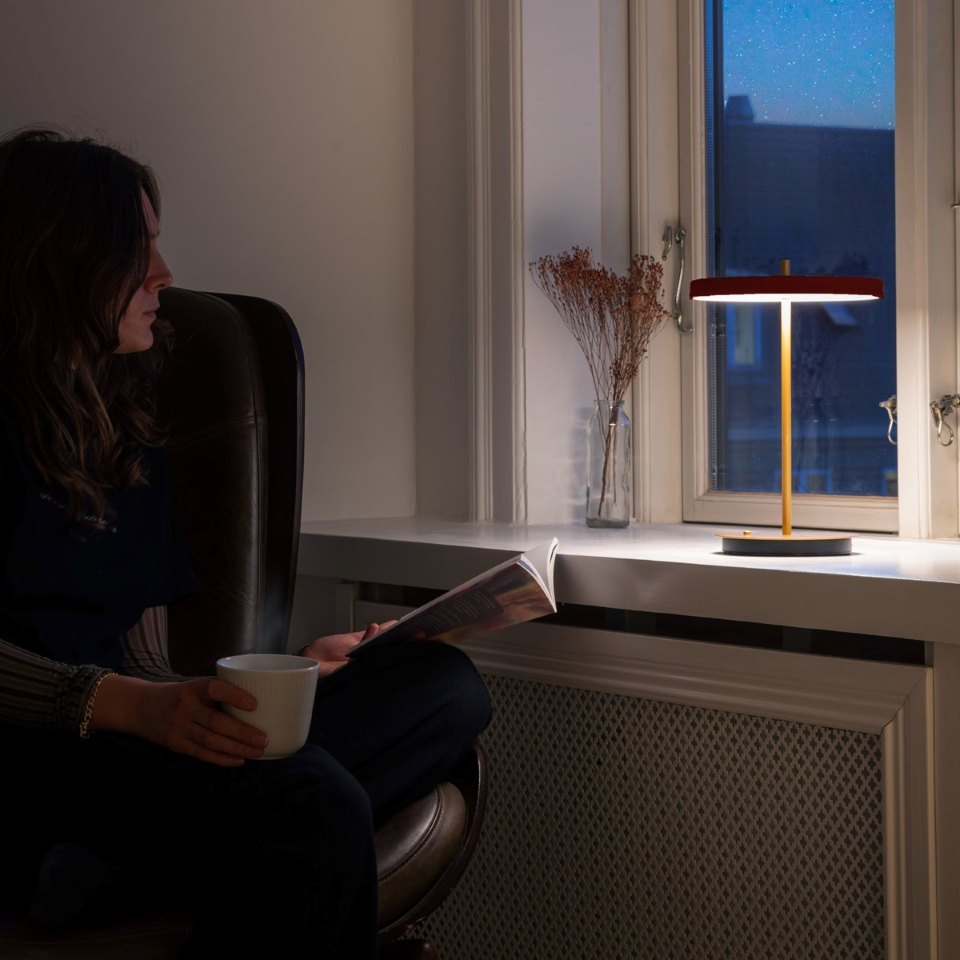 UMAGE Asteria Move LED Portable Table Lamp in Ruby Red — styled interior view 6