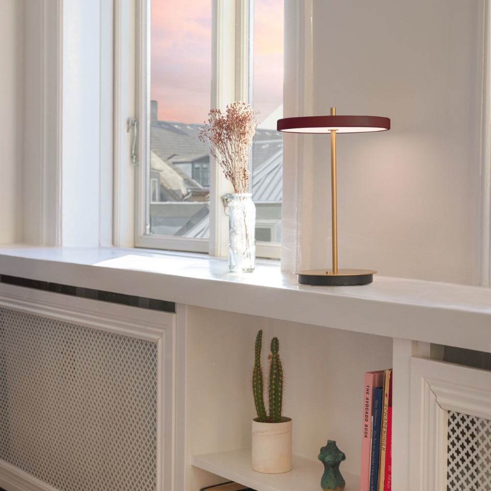 UMAGE Asteria Move LED Portable Table Lamp in Ruby Red — styled interior view 4