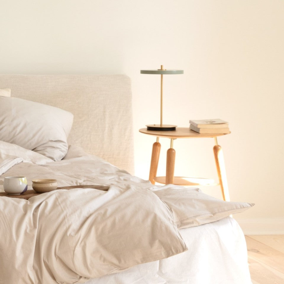 UMAGE Asteria Move LED Portable Table Lamp in Nuance Olive — styled interior view