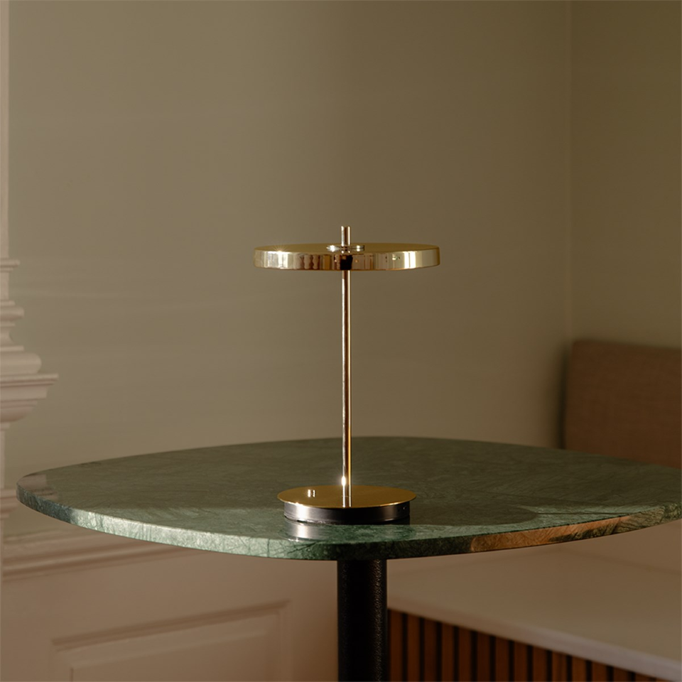 UMAGE Asteria Move Portable Table Lamp - Polished Brass / Brass — styled interior view